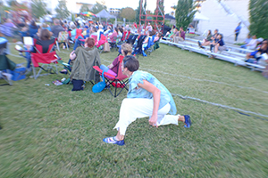 actor kneeling behind audience